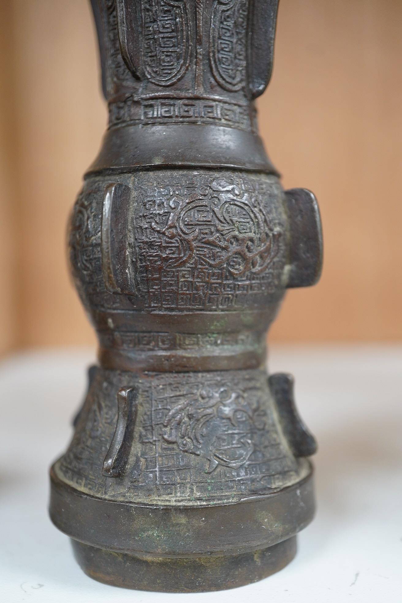 A pair 17th/18th century Chinese archaistic bronze gu vases, and a similar square vase, fanggu, Ming dynasty, tallest 18cm. Condition - poor to fair